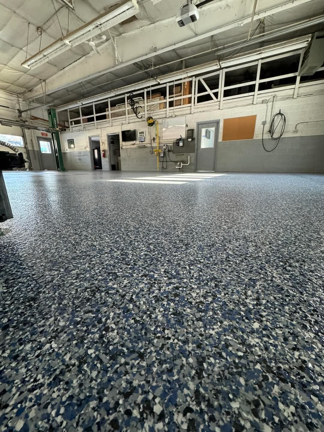 Blue and grey flake epoxy floor in a service shop