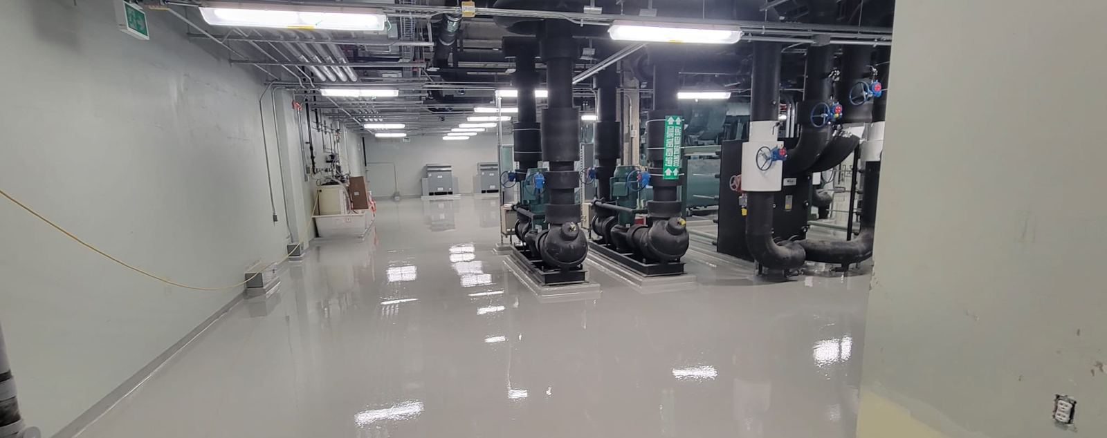High-gloss grey epoxy in a mechanical room with pumps